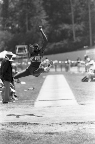 Carl Lewis completing a long jump, Los Angeles, 1982