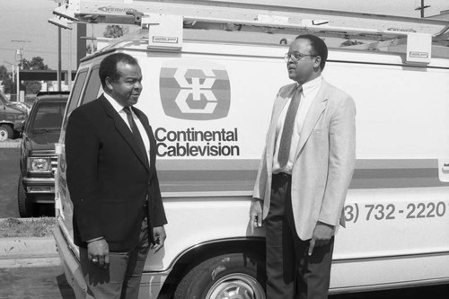 Crenshaw businessmen standing next to a Continental Cablevision van, Los Angeles, 1989