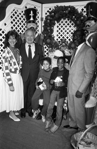 Baldwin Hills Crenshaw Plaza visitors posing with Santa, Los Angeles, 1989