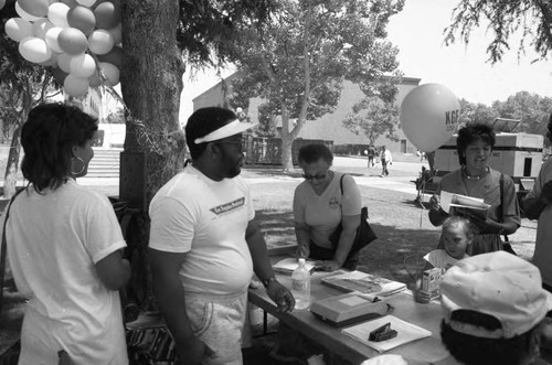 People visiting an exhibitor at the Black Family Reunion, Los Angeles, 1989