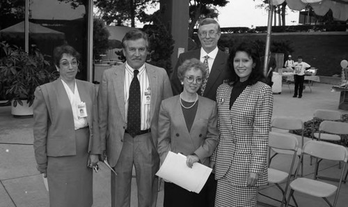 Men and women posing together on a patio at TRW, Hawthorne, California, 1994