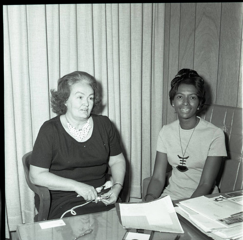 Doris Davis sitting at a desk with an unidentified woman, Los Angeles, 1973