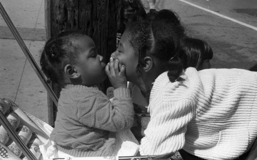 Children talking together during the South Central Los Angeles Easter Parade, Los Angeles, 1983