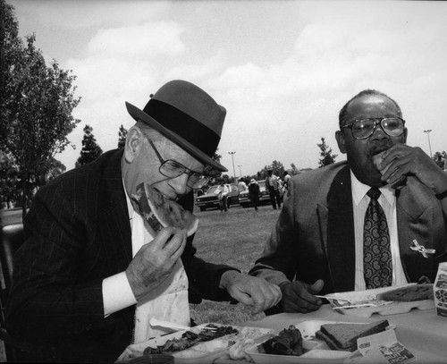 Kenneth Hahn and Brad Pye, Jr., eating together at a picnic, Los Angeles