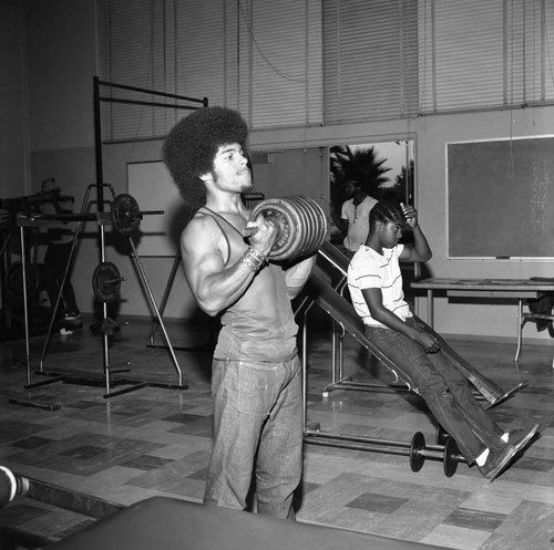 Men exercising in the Compton College gym, Compton, 1972