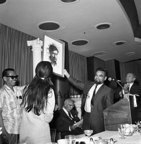 Holding a portrait, Los Angeles, 1966