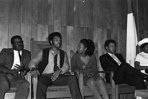 Jesse Jackson and Gladys Knight sitting together in conversation at Victory Baptist Church, Los Angeles, 1970