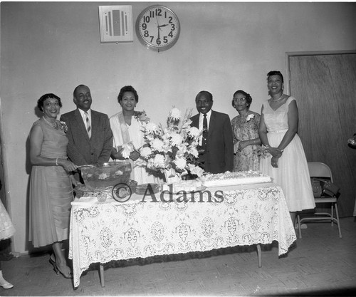 Men and women at table with refreshments, Los Angeles, 1958