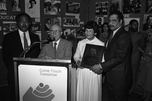 Miriam Matthews holding an award presented by Gus Hawkins, Julian Dixon, and Mervyn Dymally, Los Angeles, 1984