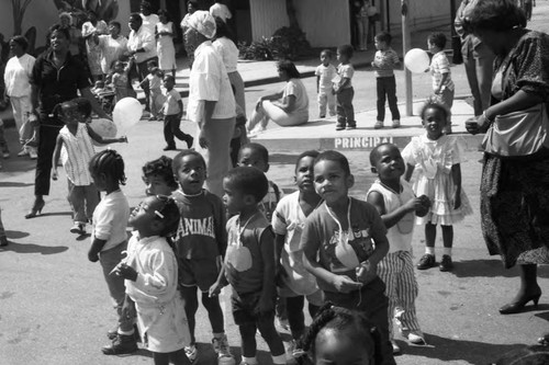 Child Development Center children and adults looking up at balloons, Los Angeles, 1987