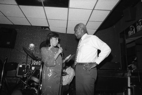 Reve Gipson presenting Nate Holden with an award, 1987