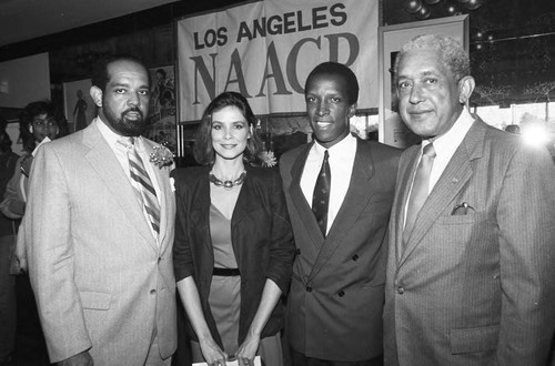 Dorian and Nancy Harewood posing with others at the premiere of "The Jesse Owens Story," Los Angeles, 1984
