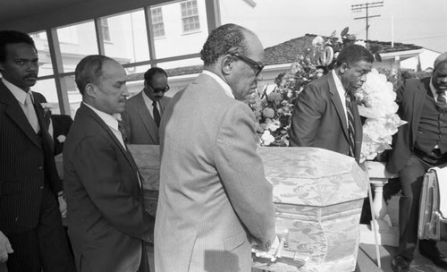 Pallbearers carrying the casket of boxer Watson Jones, Los Angeles, 1983