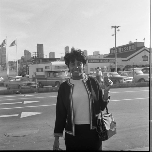 Woman stands in front of street, Los Angeles, 1966