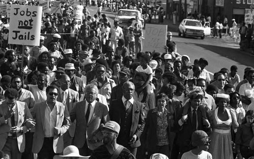 Community leaders march with a crowd during a birthday celebration for Dr. Martin Luther King, Jr., Los Angeles, ca. 1987