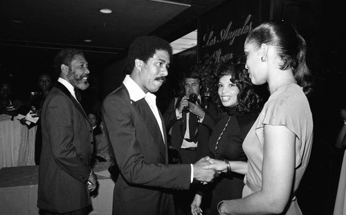 Richard Pryor greeting a hostess at the NAACP Image Awards, Los Angeles, 1978