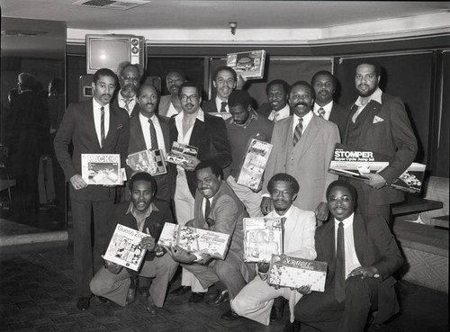 American Philanthropy Association, Inc members posing with board games, Los Angeles, 1983