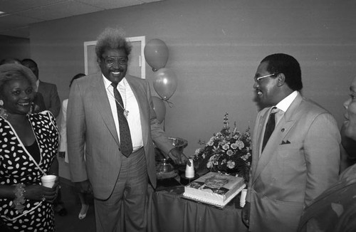 Black Business Association guest speaker Don King with his cake, Los Angeles, 1991