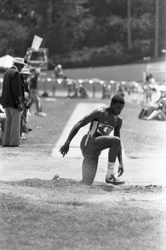 Carl Lewis completing a long jump, Los Angeles, 1982