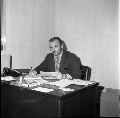 Sgt. J. V. Fette sitting at his office desk, Los Angeles
