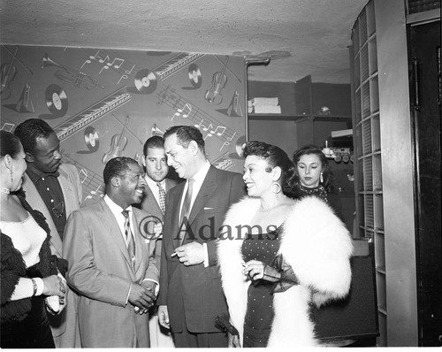 Erroll Garner talking with others at the Tiffany Club, Los Angeles, 1954