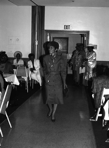 Woman walking among tables during during a Los Angeles Urban League event, Los Angeles, 1993