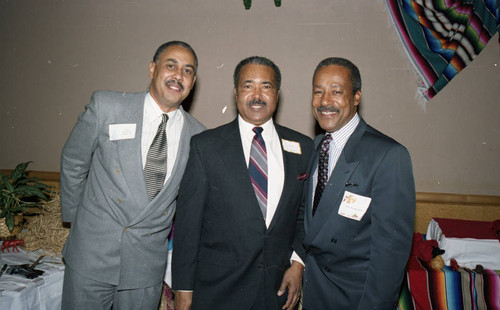 Atkins & Evans holiday party guests posing together, Los Angeles, 1994