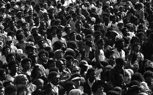 Crowd listening to a speaker during a celebration of Dr. Martin Luther King, Jr.'s birthday, Los Angeles, ca. 1987