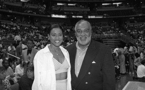 Lela Rochon and an unidentified man posing during "A Midsummer Night's Magic" basketball tournament, Los Angeles, 1995