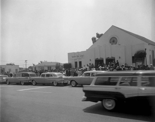 Funeral attendees outside church, Los Angeles