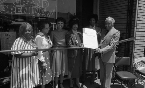 Frankie and Douglas Bell posing with Ruth Washington, Pat Russell and others at a ribbon cutting, Los Angeles, 1984