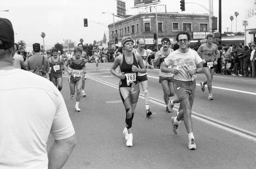 Runners passing spectators on Crenshaw Blvd. during the first LA Marathon, Los Angeles, 1986