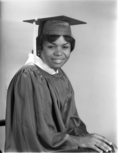 Christina Taylor sitting for a studio graduation portrait, Los Angeles