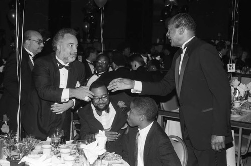 Tom Bradley greeting Danny Bakewell at a dinner, Los Angeles, 1989