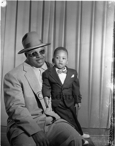 Man sits with a child; Los Angeles, 1955