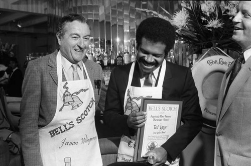 Ted Lange holding a most famous bartender award, Los Angeles, 1983