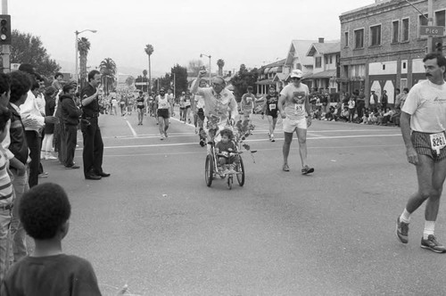 Man pushing a stroller in the first LA Marathon, Los Angeles, 1986