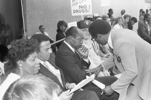 Tom Bradley, Andrew Young, and Edward Vincent conferring at an anti-drug rally, Inglewood, California, 1986