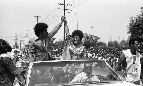 Clarence Williams, III and Gloria Foster riding in a Watts Summer Festival parade, Los Angeles, ca. 1971