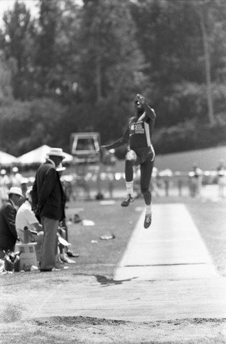 Carl Lewis completing a long jump, Los Angeles, 1982