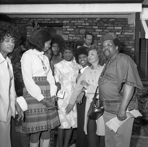 Shirley Chisholm posing among a crowd at Compton College, Compton, 1972