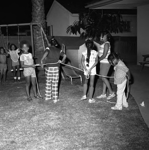 Donald Bohana's children and others playing in the backyard, Los Angeles, 1976