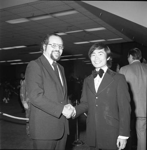 Dr. Kenneth Washington posing with George Takei at an event for Mayor Bradley, Los Angeles,1974