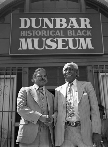 Men posing in front of the Dunbar Historical Black Museum, Los Angeles, 1983