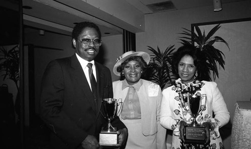 Dr. C. Z. Wilson, Helen Rice Frederick, and June B. Patterson posing together with awards, Los Angeles, 1986