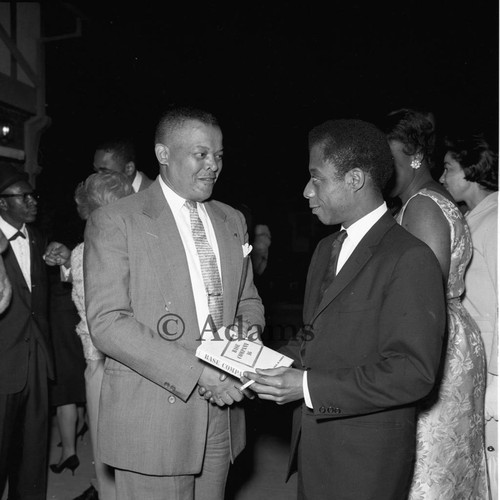 James Baldwin talking with an unidentified man at a cocktail party, Los Angeles, 1964