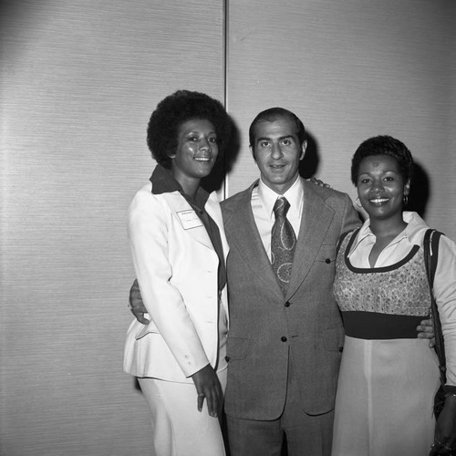 Bob Moretti posing with two women at the California Black Elected Officials Conference, Los Angeles, 1973