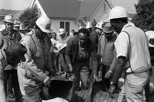 First responders at the scene of a sewer explosion and flash fire, Los Angeles, 1972