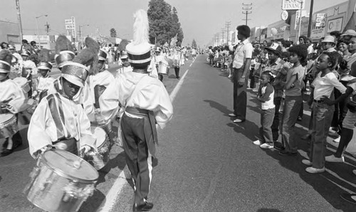 Spectators watching a marching band during a parade, Los Angeles, 1982