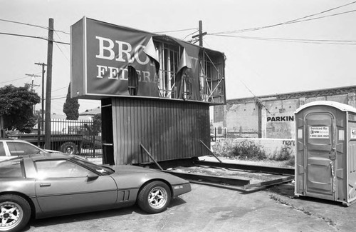 Destroyed Broadway Federal Savings and Loan sign sitting in a parking lot, Los Angeles, 1992